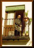 Man on balcony in The Albaicín (Arab quarter), in Granada, Andalusia, Spain.